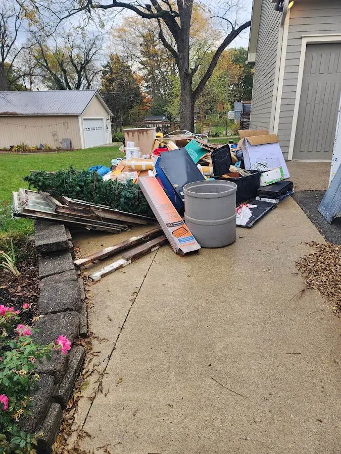 Dumpster being loaded with debris for 10 Yard Dumpster Rental in Olney